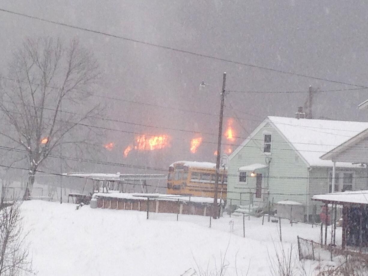 A fire burns Monday after a train derailment near Charleston, W.Va.