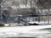 A train derailment that sent a tanker with crude oil into the Kanawha River on Monday was still smoldering Tuesday near Mount Carbon, W.Va. Fires burned for hours after the train carrying more than 100 tankers of crude oil derailed, sending a fireball into the sky and threatening the water supply of nearby residents, authorities and residents said Tuesday. Officials evacuated hundreds of families and shut down two water treatment plant following the Monday afternoon derailment.