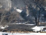 A crew member walks near the scene of a train derailment near Mount Carbon, W.Va., Tuesday, Feb. 17, 2015.