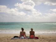 Ali Junell of Portland, left, and Kristen Carmichael of Los Angeles sit May 19 on the beach at Waimanalo Bay Beach Park in Waimanalo, Hawaii. The beach was listed as No.