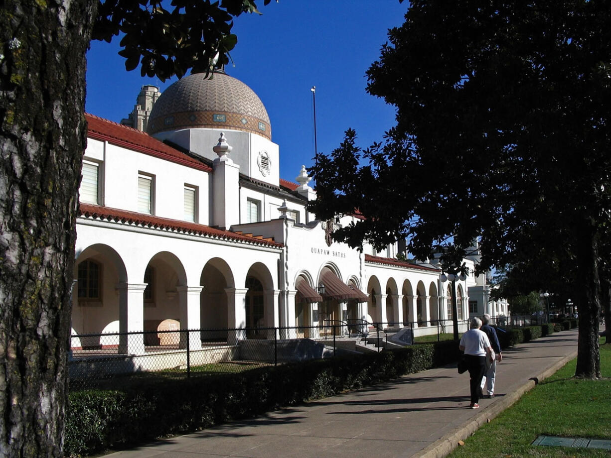 Associated Press files
People walk by the Quapaw Baths on Bathhouse Row, a National Landmark Historic district in Hot Springs National Park, in Hot Springs, Ark. By 1983, all but one of the bathhouses had closed, but their elaborate exteriors have been preserved.