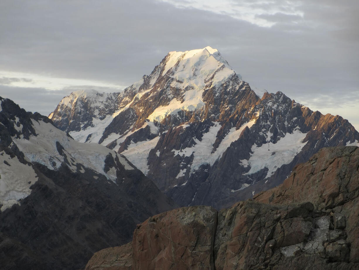 Mount Cook, New Zealand's highest mountain, glows at sunset in Twizel, New Zealand.