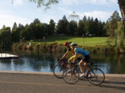 Bike riders along a section of the Centennial Trail, a 60-mile paved biking and hiking trail that connects Spokane with Coeur d'Alene, Idaho, and Lake Coeur d'Alene.