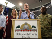 Gov. Rick Scott speaks accompanied by Florida Attorney General Pam Bondi, Lt. Gov. Carlos Lopez-Cantera, left, and Maj. General Michael Calhoun, right, during a news conference at the Hillsborough County Emergency Operations Center in Tampa, Fla. on Friday, Aug. 28, 2015. The governor and several local officials were on hand at the county E.O.C. to discuss Tropical Storm Erika and its possible impact on the state. (Chris Urso/The Tampa Tribune via AP)  ST.