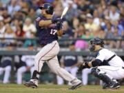 Minnesota Twins designated hitter Kendrys Morales (17) hits a two-run double in the fifth inning of a baseball game against the Seattle Mariners, Thursday, July 10, 2014, in Seattle. (AP Photo/Ted S.