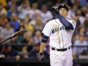 Seattle Mariners' Logan Morrison tosses aside his bat after striking out looking to end the seventh inning against the Minnesota Twins in a baseball game Wednesday, July 9, 2014, in Seattle.