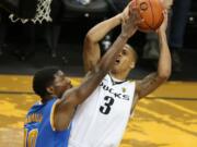 Oregon's Joseph Young, right, tries to shoot around UCLA's Isaac Hamilton during the second half Saturday, Jan. 24, 2015. Oregon won 82-64.