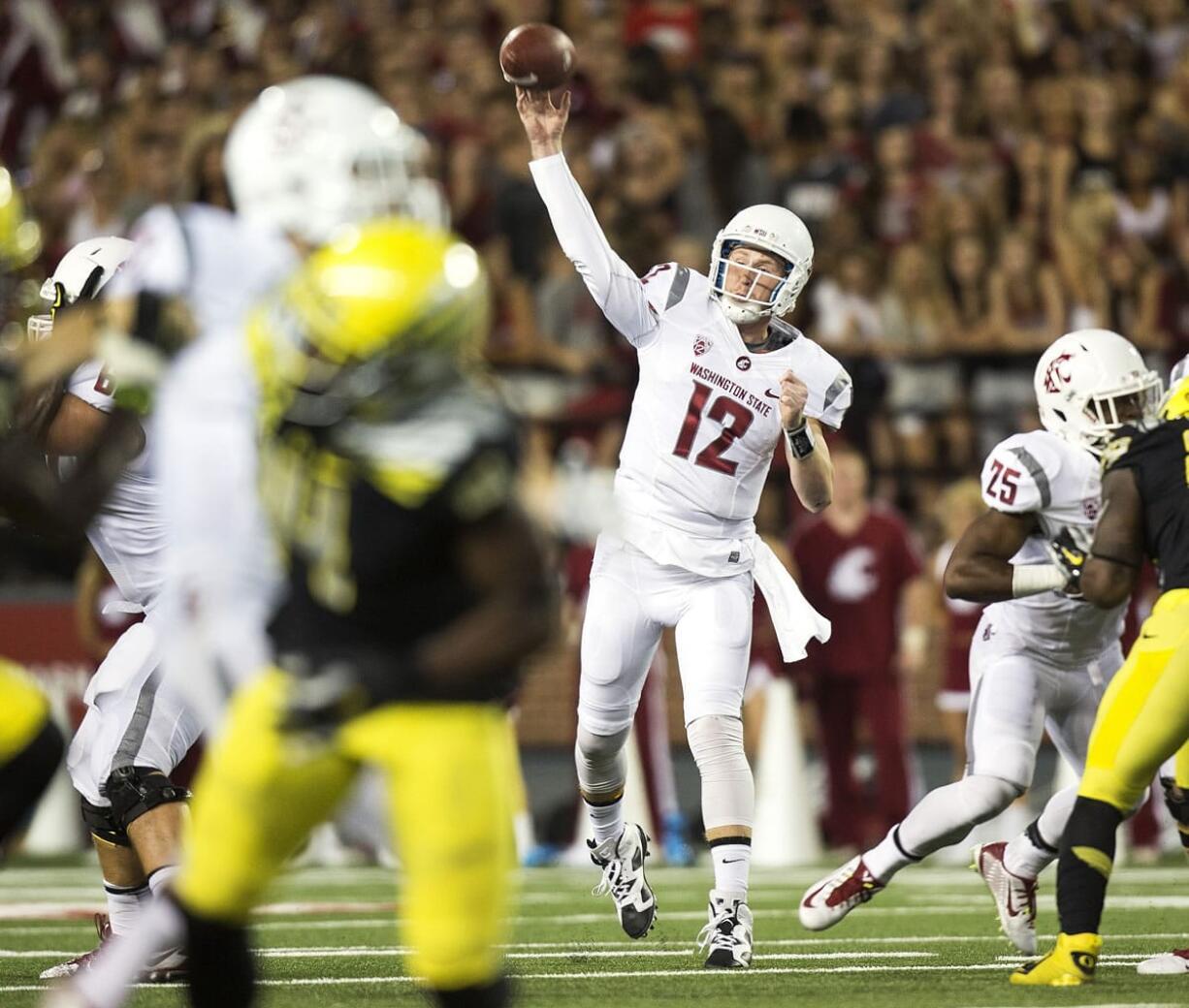 Washington State quarterback Connor Halliday (12) throws a pass to wide receiver River Cracraft against Oregon during the first quarter Saturday, Sept. 20, 2014, at Martin Stadium in Pullman, Wash.