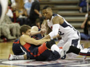 Atlanta Hawks' Kyle Korver, left, and Portland Trail Blazers' Damian Lillard, right, scramble for the ball during the USA Basketball Showcase game Friday, Aug. 1, 2014, in Las Vegas.