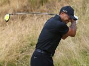 Tiger Woods reacts to his tee shot on the eighth hole during the first round of the U.S.