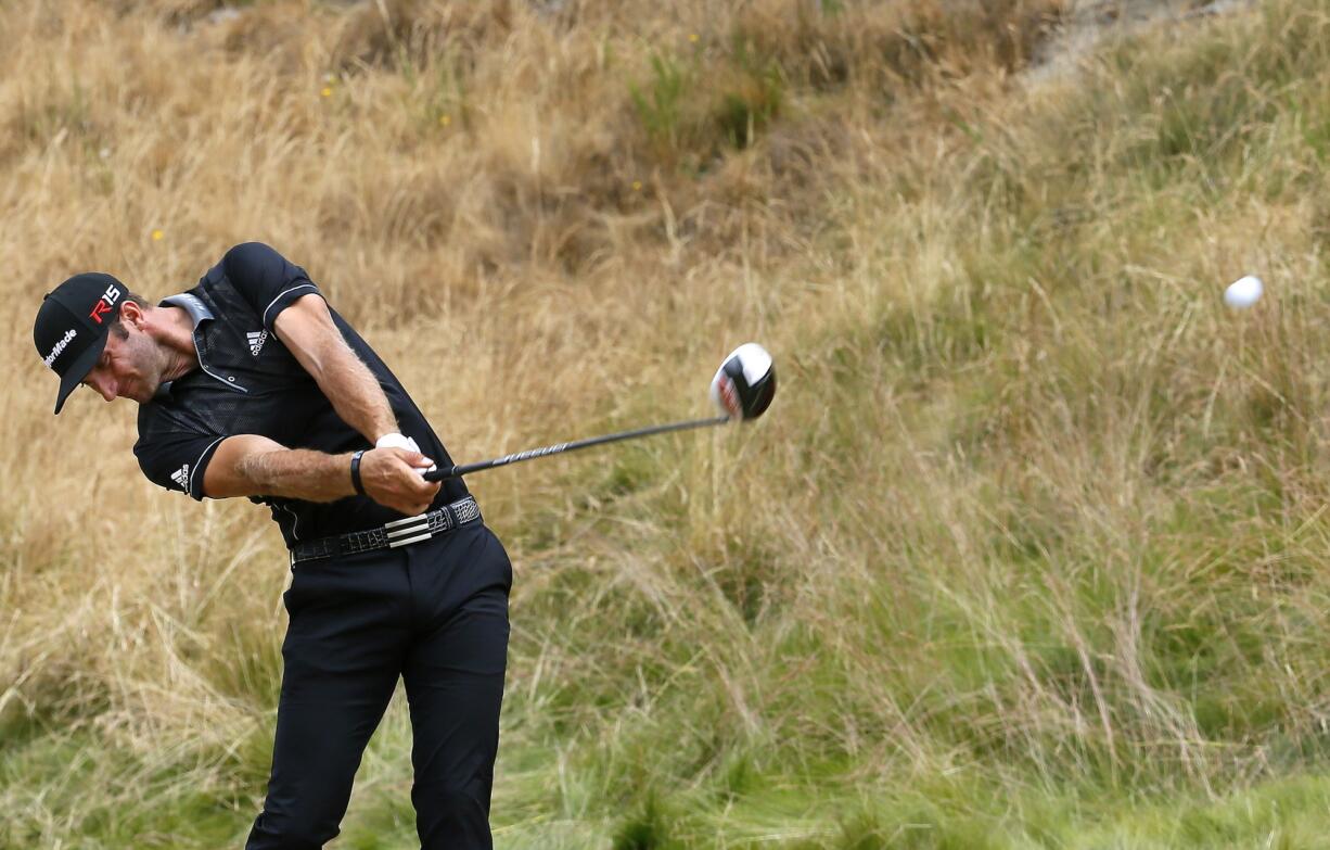 Dustin Johnson hits his tee shot on the eighth hole during the first round of the U.S.