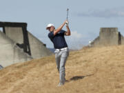 Jordan Spieth hits out of the tall fescue grass on the 18th hole during the second round of the U.S. Open golf tournament at Chambers Bay on Friday in University Place.