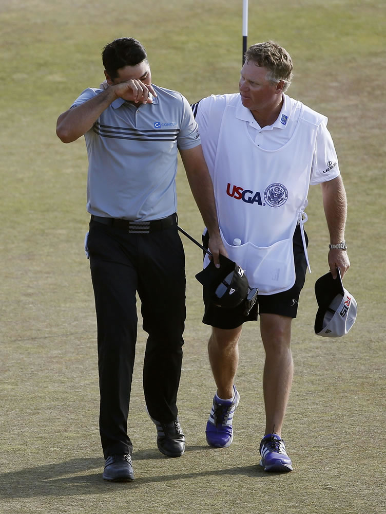 Jason Day walks up to the 18th green with his caddie Colin Swatton during third round of the U.S. Open at Chambers Bay on Saturday in University Place.