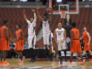 Washington center Robert Upshaw, third from left, celebrates with forward Jernard Jarreau, center, and guard Andrew Andrews, third from right, as UTEP forward Julian Washburn, left, guard Trey Touchet, second from left, guard Omega Harris, second from right, and forward Cedrick Lang look on. Washington won 68-65. (AP Photo/Mark J.