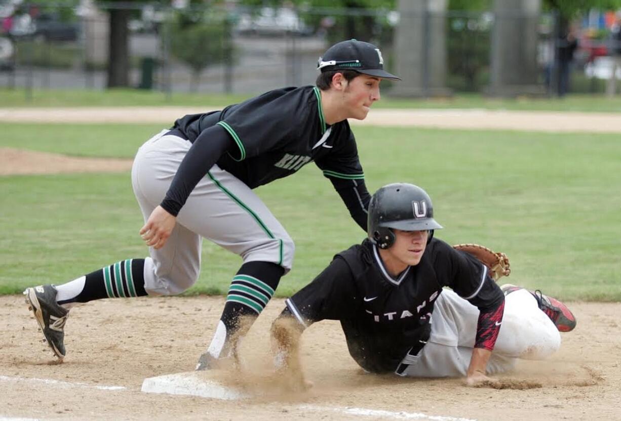 Union's Branden Whalen (7) makes it back to the bag before being tagged by Kentwood's first baseman Mike Ciancio in 4A state regional on Saturday, May 23, 2015, at Hiedelberg Park in Tacoma. Kentwood beat Union 17-6 to advance.