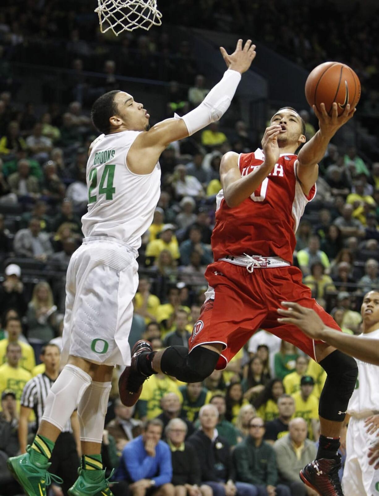 Oregon's Dillon Brooks (24) defends against Utah's Brekkott Chapman during the first half in Eugene, Ore., Sunday, Feb. 22, 2015.