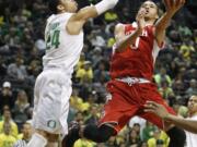 Oregon's Dillon Brooks (24) defends against Utah's Brekkott Chapman during the first half in Eugene, Ore., Sunday, Feb. 22, 2015.