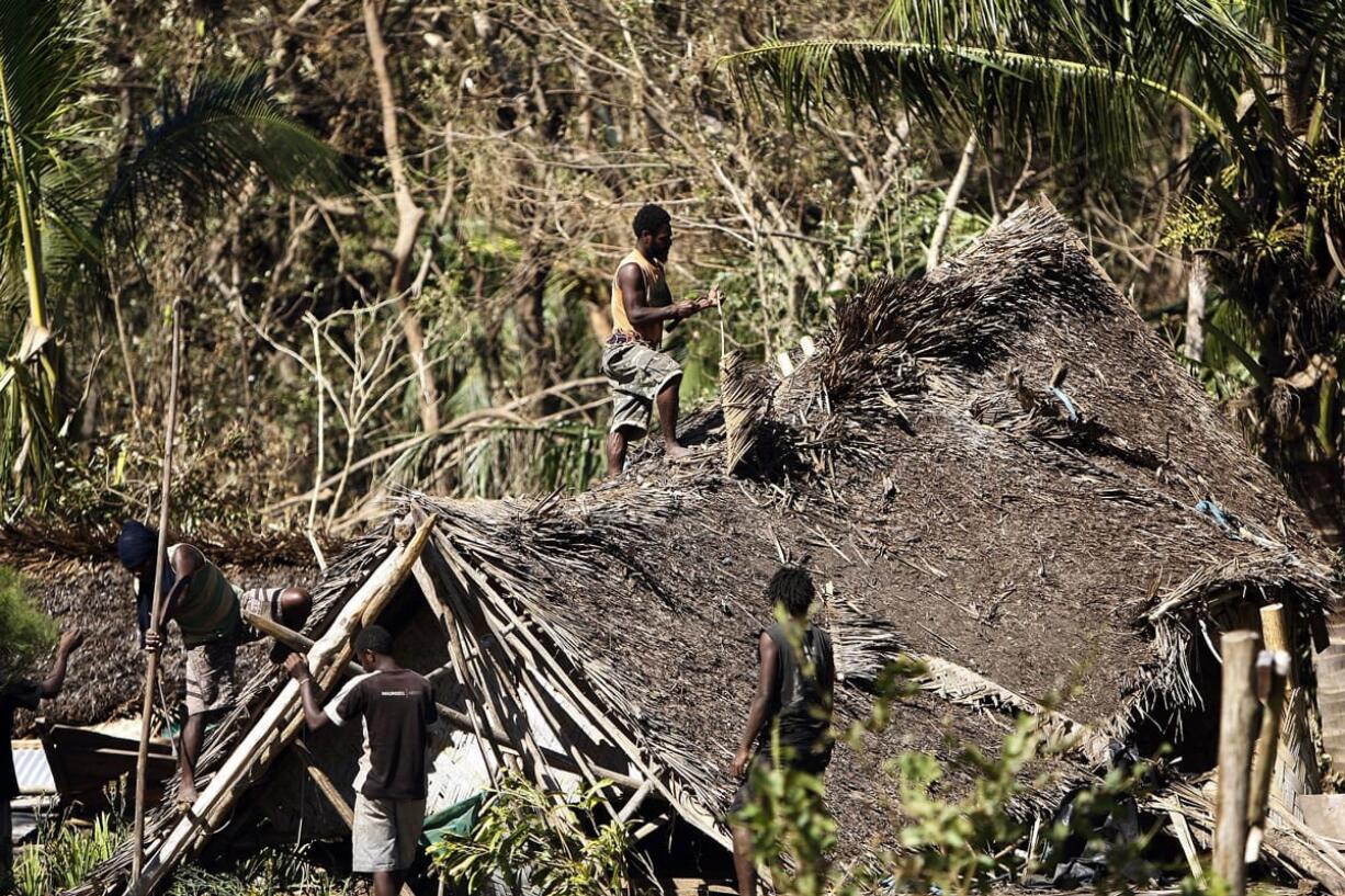 Young men on Thursday take apart a hut destroyed by Cyclone Pam on Tanna Island, Vanuatu. Tanna Island in the southern part of the Vanuatu archipelago was one of the hardest hit when Cyclone Pam tore through the South Pacific nation early Saturday. The cyclone's 270 kilometer (168 mile) per hour winds pummeled lush tropical forests on Tanna into a brown jumble of broken trunks and strewn branches.