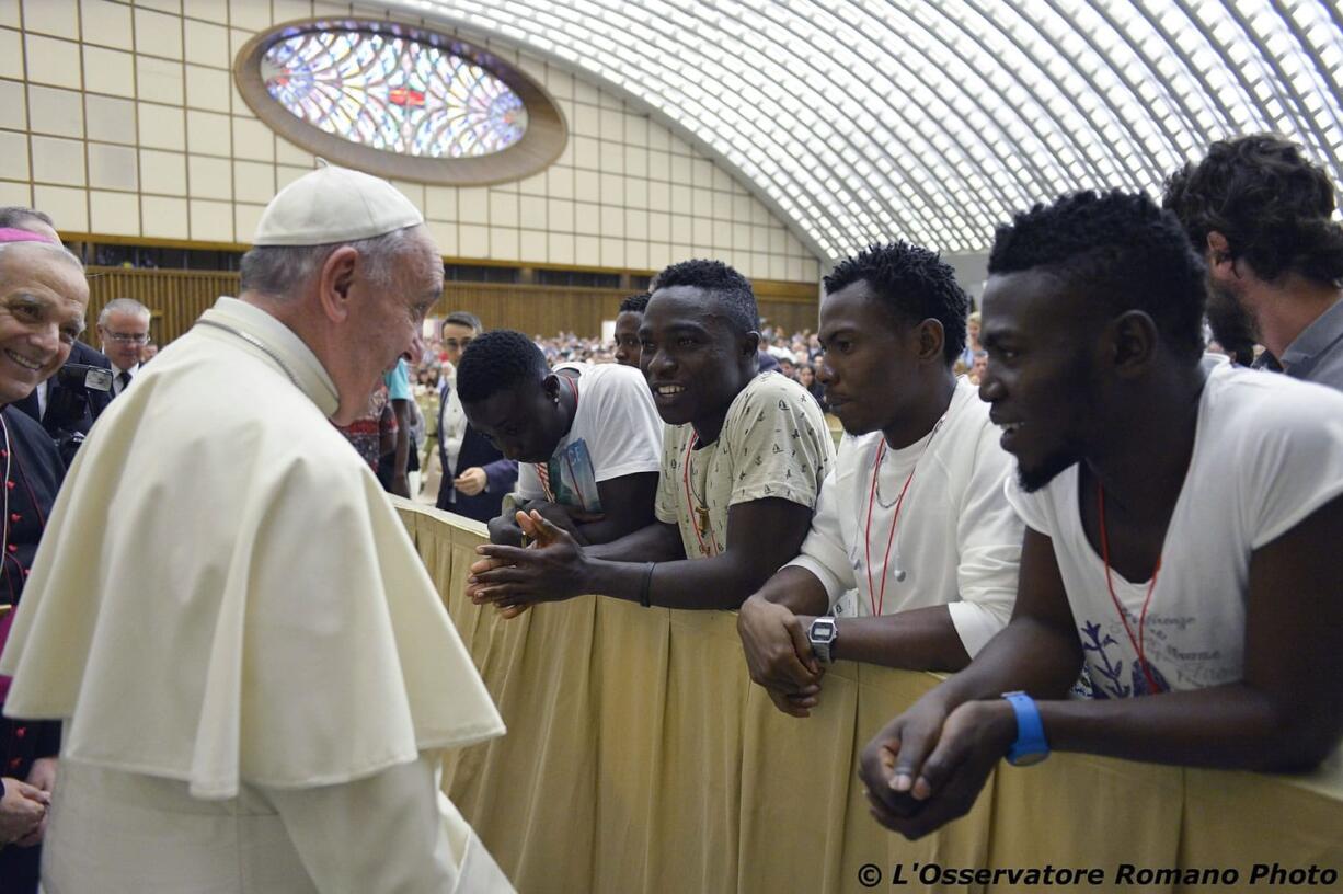 Pope Francis salutes migrants from Nigeria during his weekly general audience he held in the Pope Paul VI hall, at the Vatican on Wednesday.