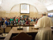 In this photo provided by the Vatican newspaper L'Osservatore Romano, Pope Francis meets with participants of the Global Meeting of Popular Movements, at the Vatican, Tuesday, Oct. 28, 2014.