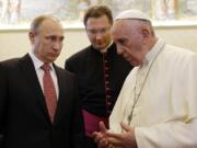 Russian President Vladimir Putin, left, listens to Pope Francis on Wednesday at the Vatican.