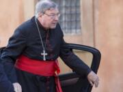 Cardinal George Pell arrives for a morning session of a synod on family issues, at the Vatican.