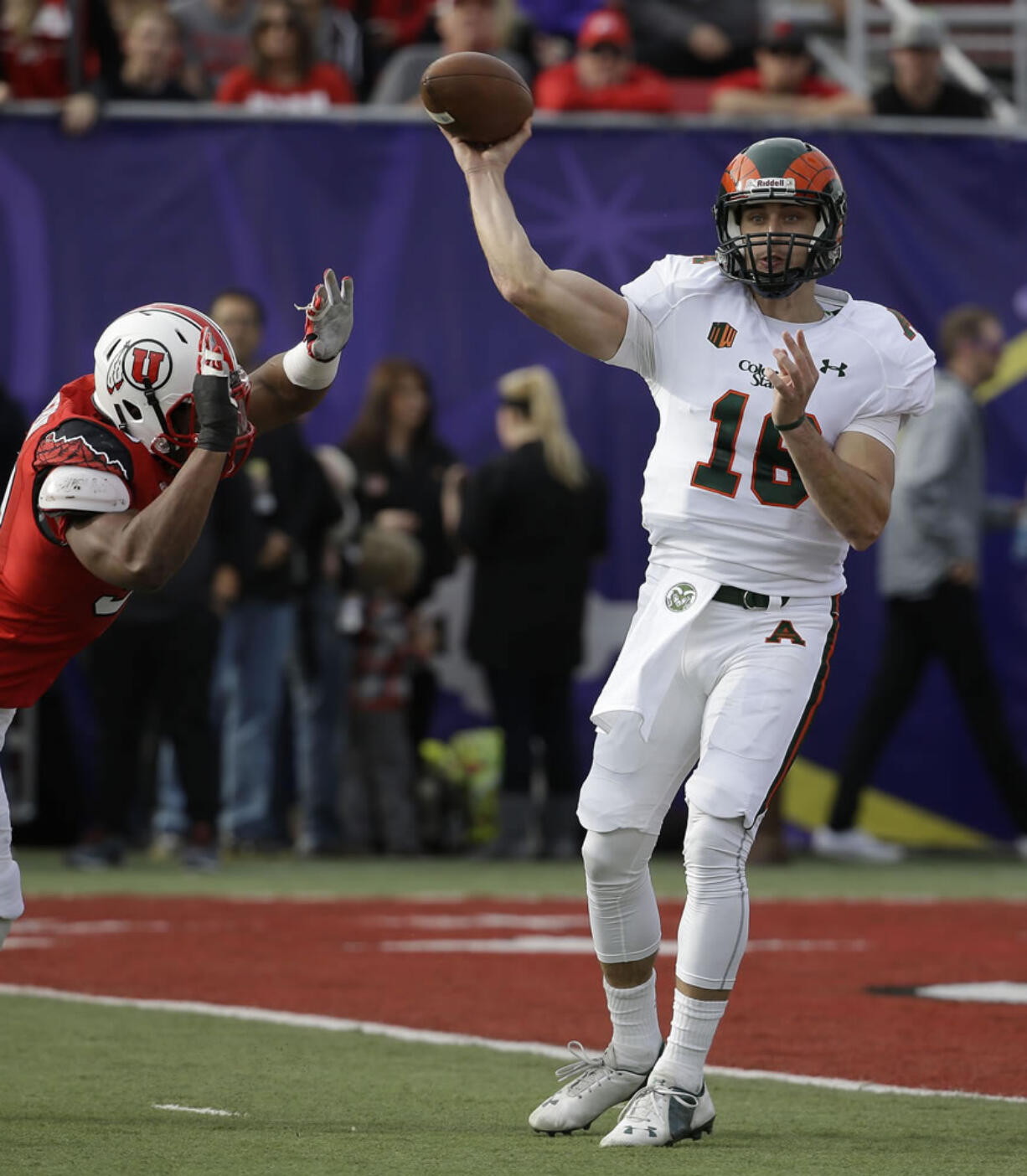 Colorado State quarterback Garrett Grayson (18) throws under pressure from a Utah defender during the first half Saturday, Dec. 20, 2014, in Las Vegas.