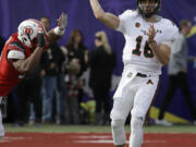 Colorado State quarterback Garrett Grayson (18) throws under pressure from a Utah defender during the first half Saturday, Dec. 20, 2014, in Las Vegas.