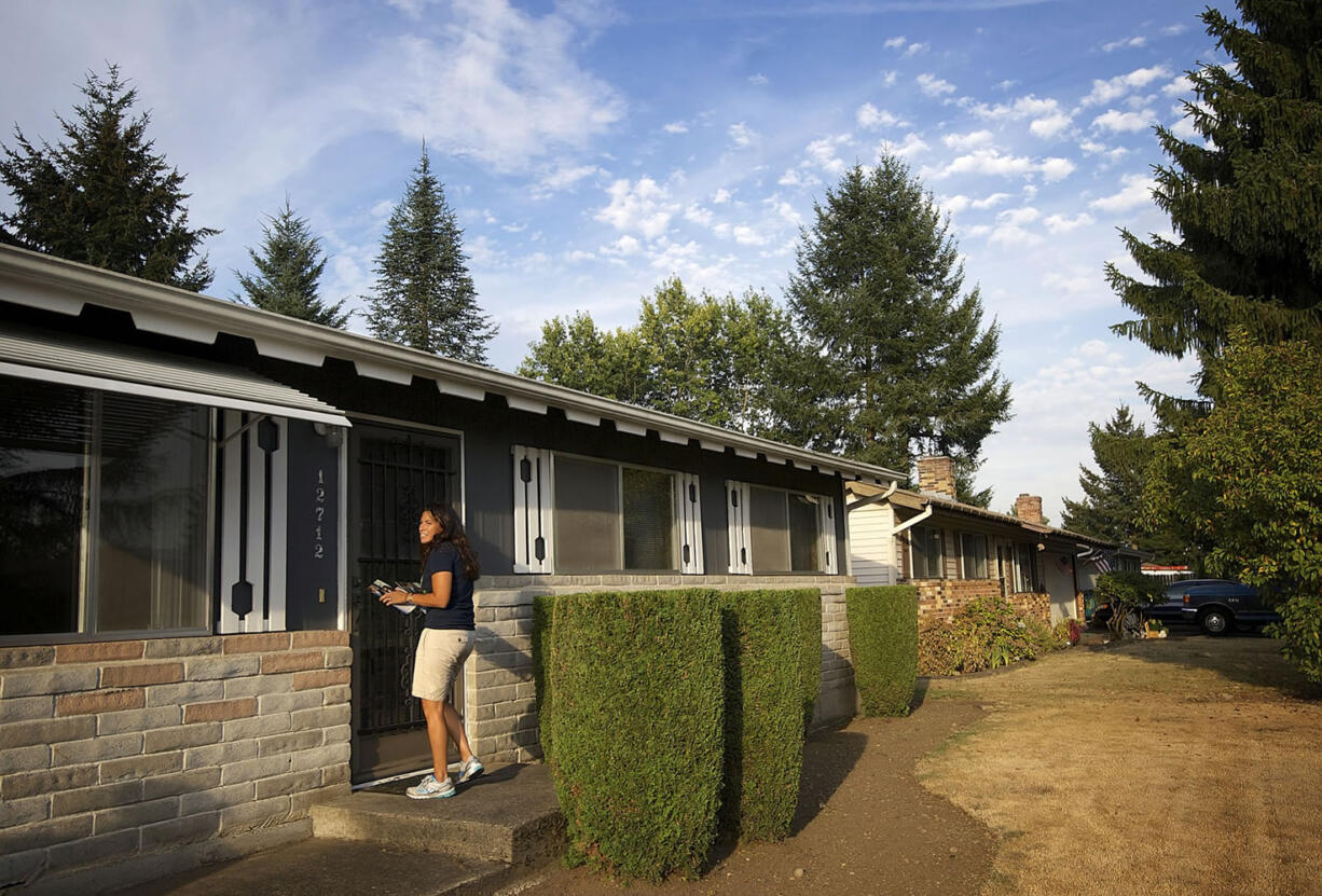 Rep. Monica Stonier, D-Vancouver, leaves a piece of campaign literature on a home.