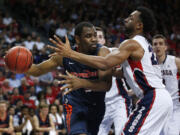 Pepperdine's Stacy Davis, left, passes around Gonzaga's Byron Wesley during the second half of the semifinals of the West Coast Conference tournament Monday, March 9, 2015, in Las Vegas.