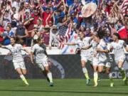 United States teammates, from left to right, Morgan Brian (14), Tobin Heath (17), Alex Morgan (13), Lauren Holiday (12), Carli Lloyd (10) and Ali Krieger (11) celebrate after Lloyd's second goal against Japan during the first half of the FIFA Women's World Cup soccer championship in Vancouver, British Columbia, on Sunday, July 5, 2015.