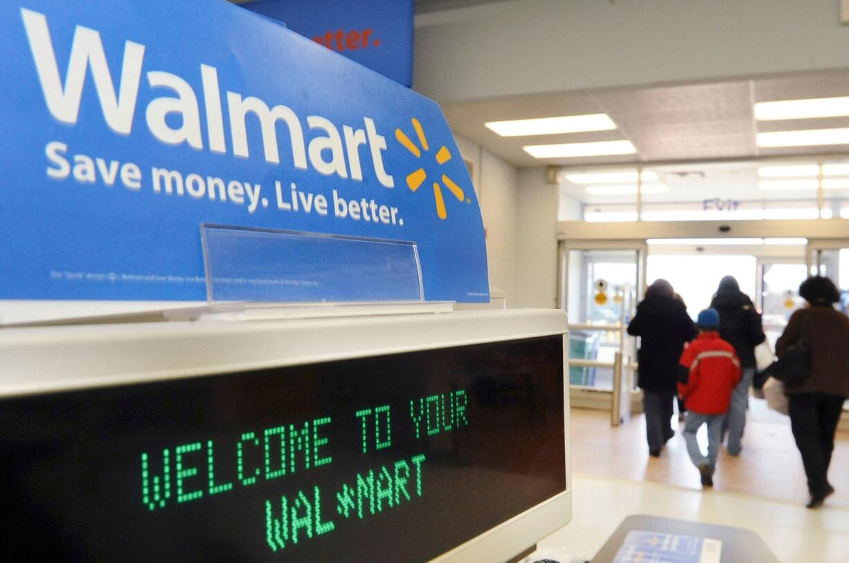 Shoppers leave a Wal-Mart in Danvers, Mass. Wal-Mart is doing whatever it takes to rope in holiday shoppers, however they want to buy. For the first time, Wal-Mart is offering free shipping on what it considers the season's top 100 hottest gifts, from board games to items related to Disney's hit film &quot;Frozen,&quot; starting today.