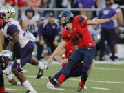 Arizona place kicker Casey Skowron (41) kicks the game-winning field goal as time expires against Washington, Saturday, Nov. 15, 2014, in Tucson, Ariz.