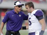 Washington head coach Chris Petersen talks to Washington quarterback Jeff Lindquist (5) against Arizona during the second half Saturday, Nov. 15, 2014, in Tucson, Ariz.