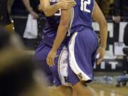 Washington's Nigel Williams-Goss, left, hugs Andrew Andrews after Andrews hit the game-winning shot at the buzzer to defeat Colorado 52-50 on Thursday in Boulder, Colo.