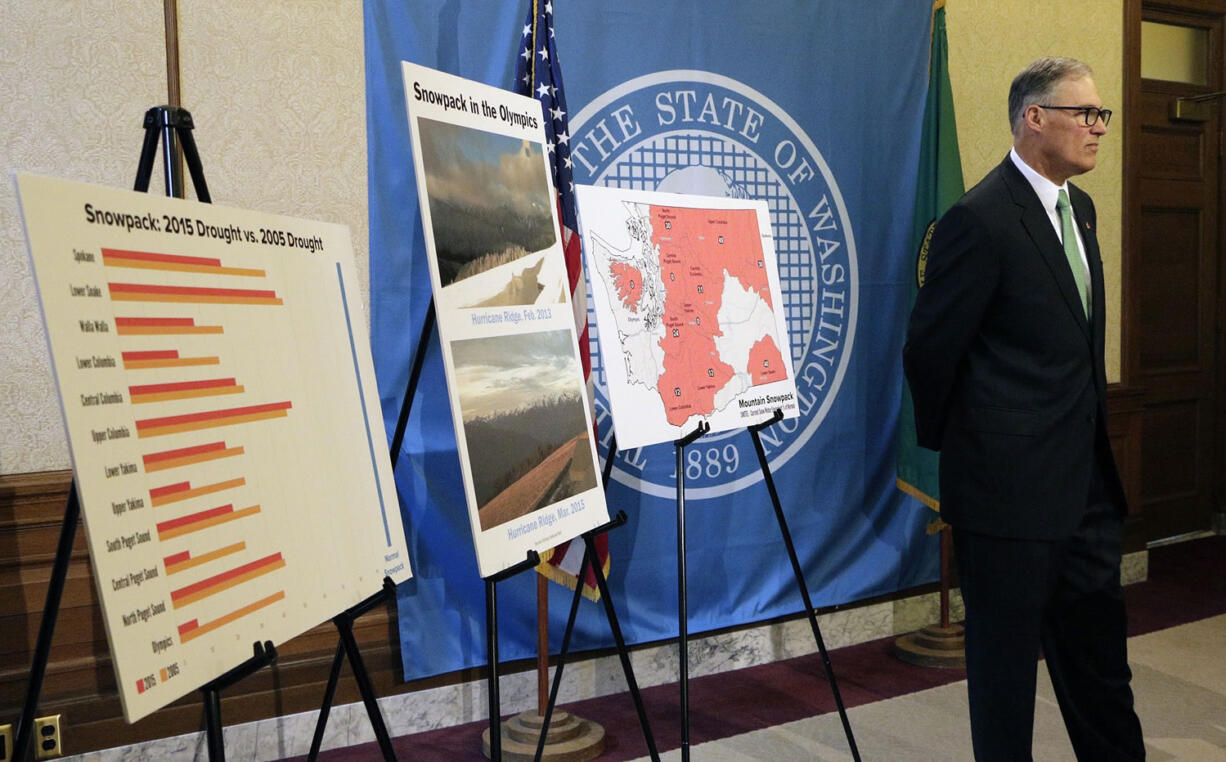 Washington Gov. Jay Inslee stands near placards displaying information on the state's drought situation, Friday, May 15, 2015, in Olympia, Wash. Inslee declared a statewide drought emergency, saying parts of the state have been severely impacted by record low snowpack levels.