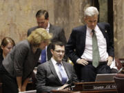 Senators gather Thursday in Olympia to watch a vote count on the Senate floor on a measure that would delay full implementation of an initiative to reduce class sizes.