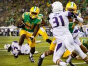 Oregon running back Royce Freeman (21) runs into the end zone for a touchdown during the fourth quarter against Washington on Saturday, Oct. 18, 2014.