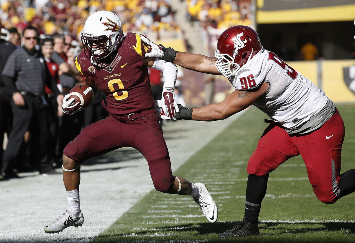 Washington State's Xavier Cooper (96) shoves Arizona State's D.J. Foster (8) out of bounds during the second half  Saturday, Nov. 22, 2014, in Tempe, Ariz. Arizona State defeated Washington State 52-31. (AP Photo/Ross D.