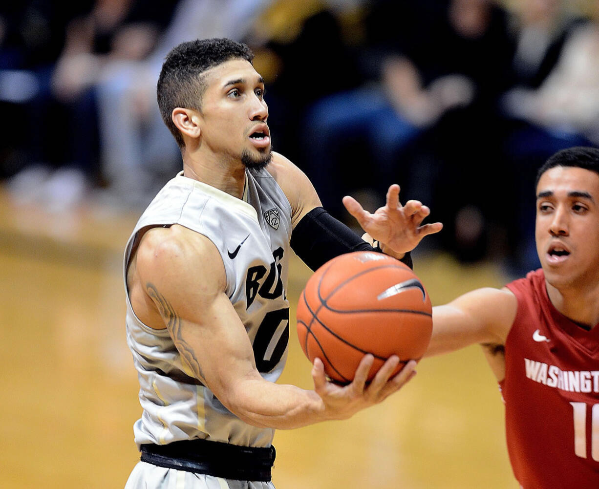 Colorado's Askia Booker drives to the basket against Washington State's Dexter Kernich-Drew during the second half Saturday, Jan. 24, 2015, in Boulder, Colo.