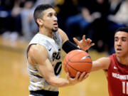 Colorado's Askia Booker drives to the basket against Washington State's Dexter Kernich-Drew during the second half Saturday, Jan. 24, 2015, in Boulder, Colo.