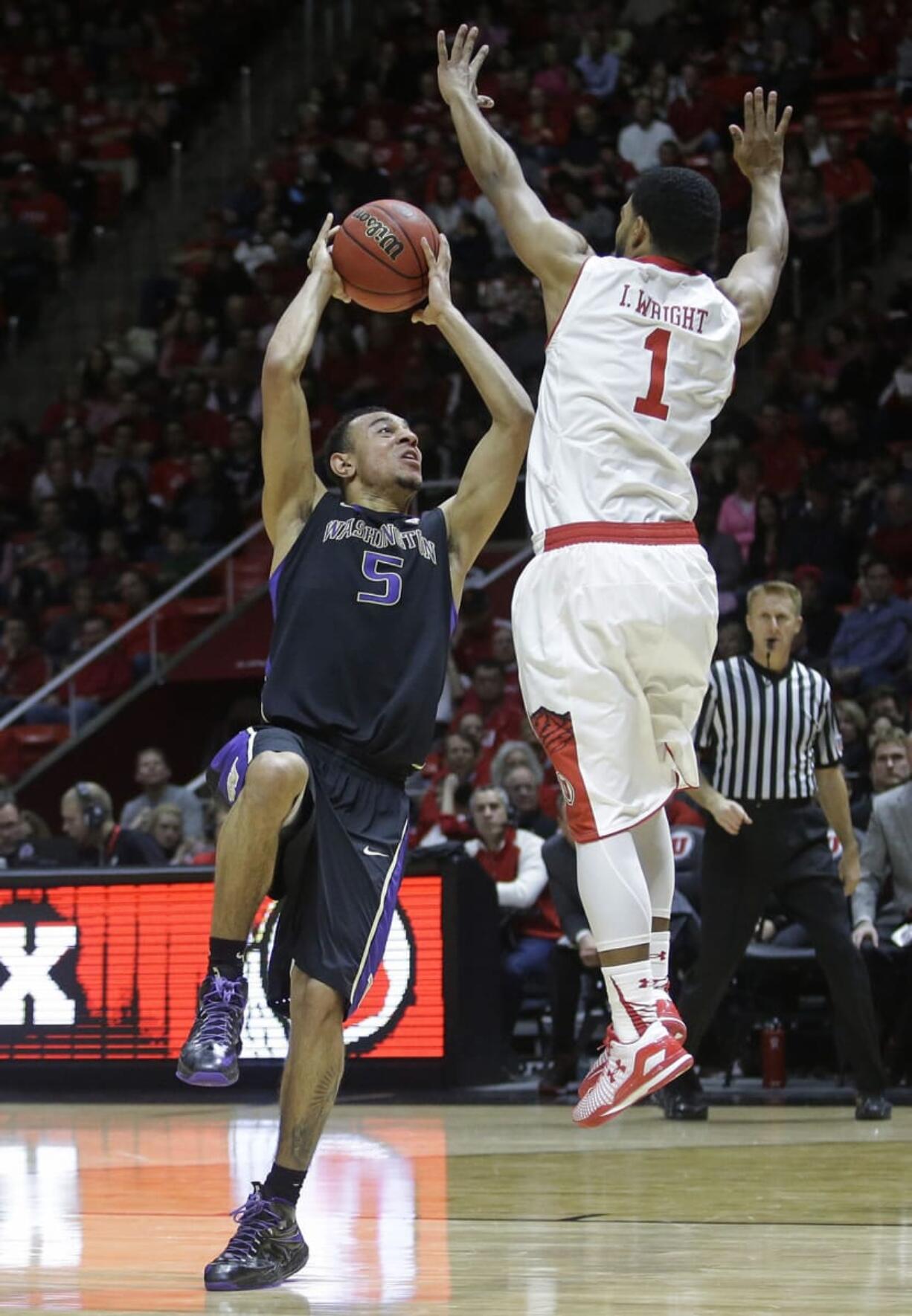 Washington guard Nigel Williams-Goss (5) shoots as Utah guard Isaiah Wright (1) defends in the first half Sunday, Jan. 25, 2015, in Salt Lake City.