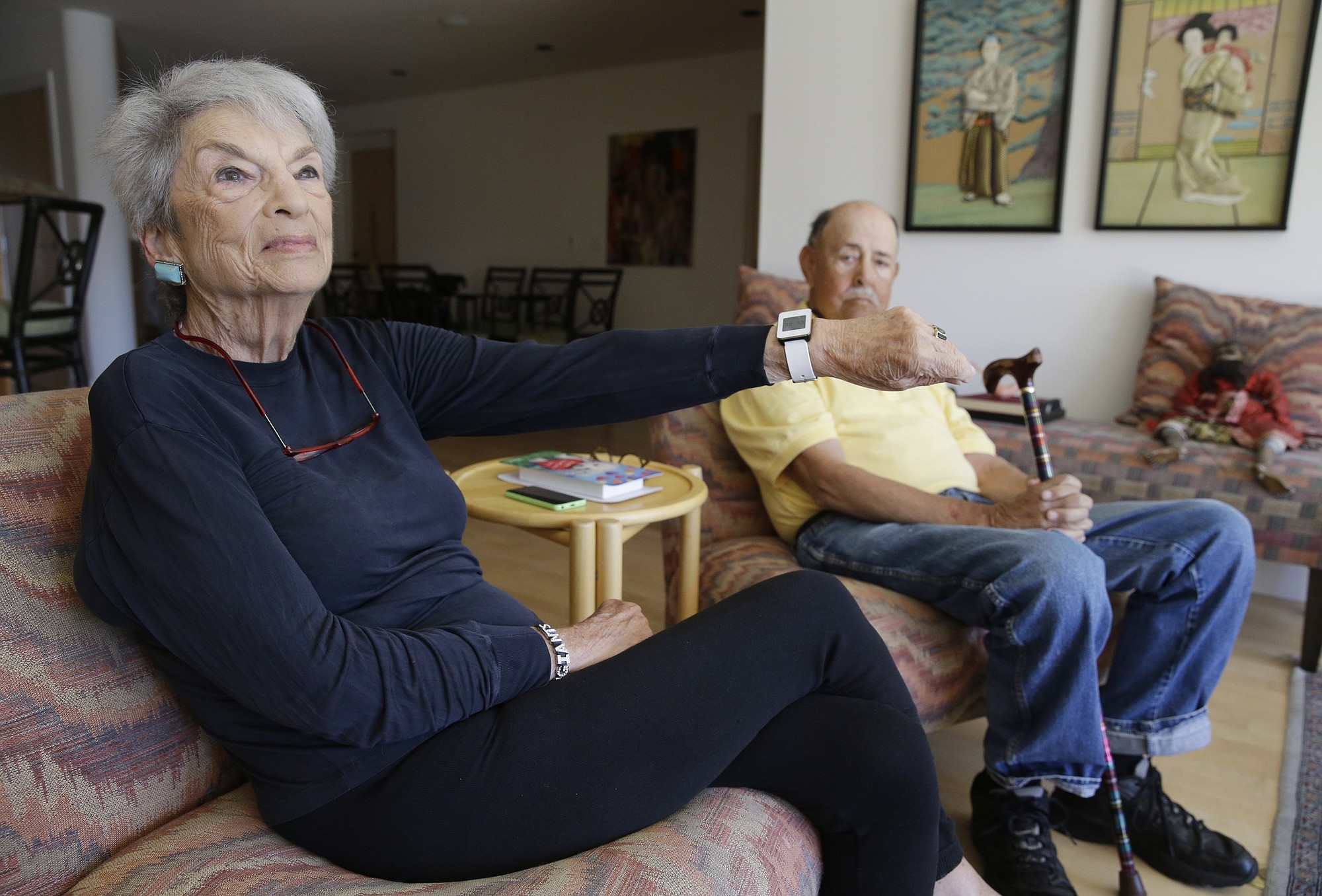 Dorothy Dworsky, 80, sitting next to her husband, Bill, 81, shows a watch she wears that keeps track of her movements at their home in San Francisco.