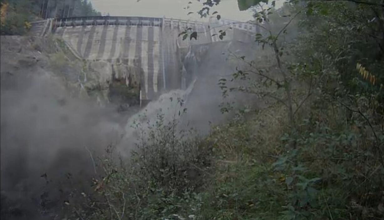 A torrent of water issues from the breached Condit Dam moments after the initial blast.