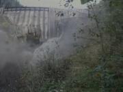 A torrent of water issues from the breached Condit Dam moments after the initial blast.