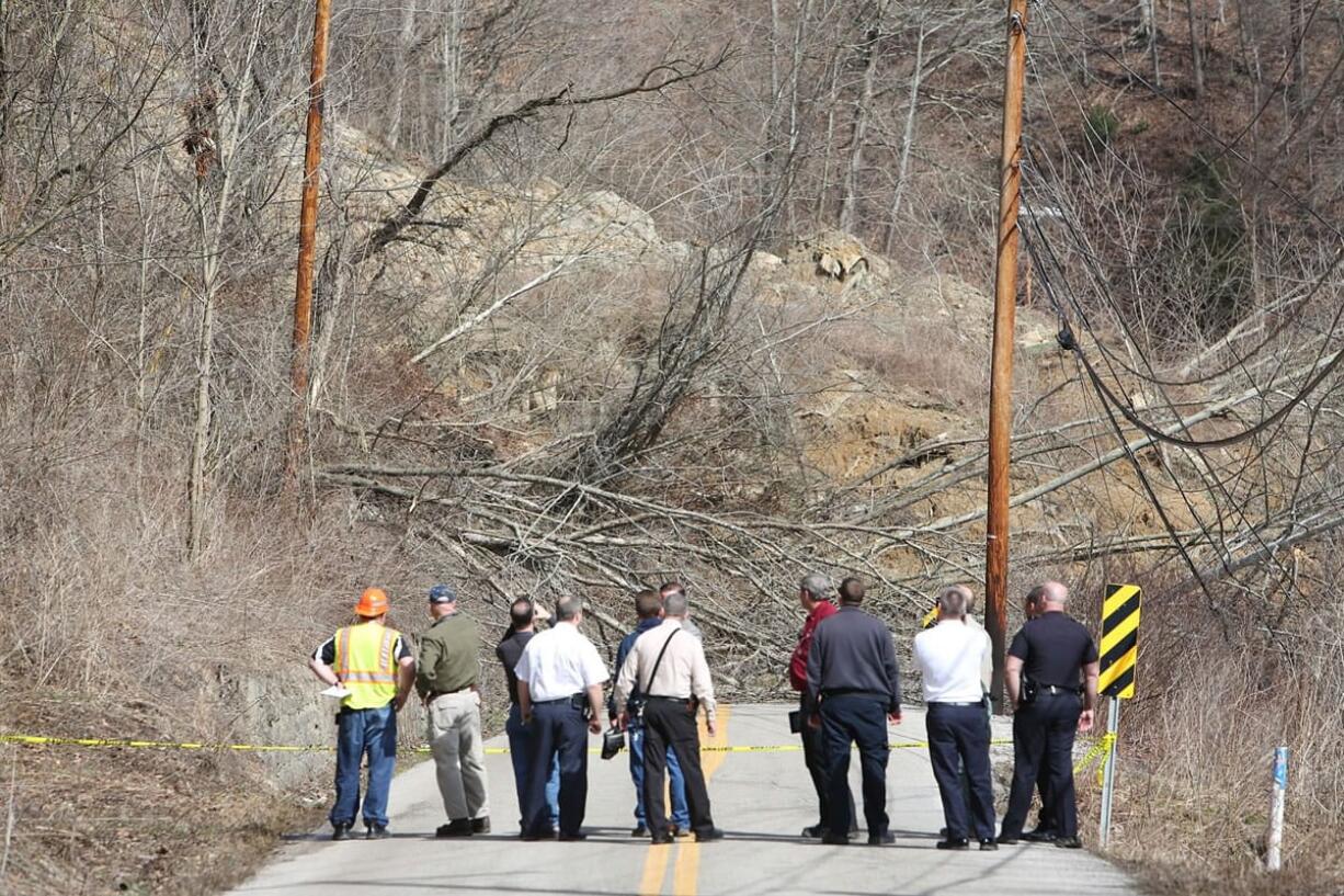 First responders assess a landslide on Keystone Drive on Thursday in Charleston, W.Va.