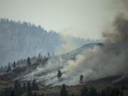 The Carlton Complex fire burns on the side of a mountain on July 20 in Carlton.