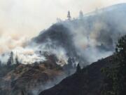 Smoke rises from the Rowena Fire west of The Dalles, Ore., on Wednesday amid high winds and dry conditions.