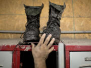 Coal miner Johnny Turner, 35, puts his coal boots on top of his locker after finishing a shift at the Perkins Branch coal mine in Cumberland, Ky., on Oct. 15.