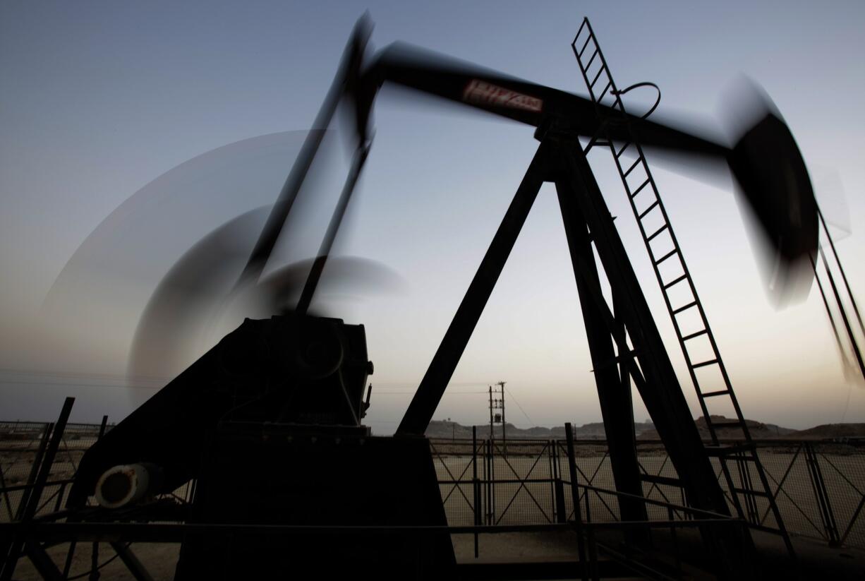 Associated Press files
An oil pump works at sunset in the desert oil fields of Sakhir, Bahrain, in October.